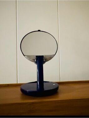 Blue Countertop Makeup Mirror, adjustable arm, lights on mirror.